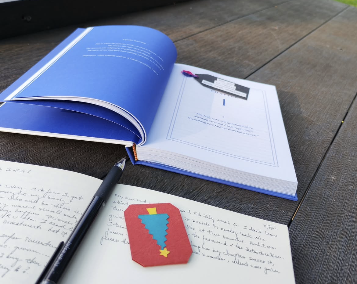 SPARK book open beside a journal